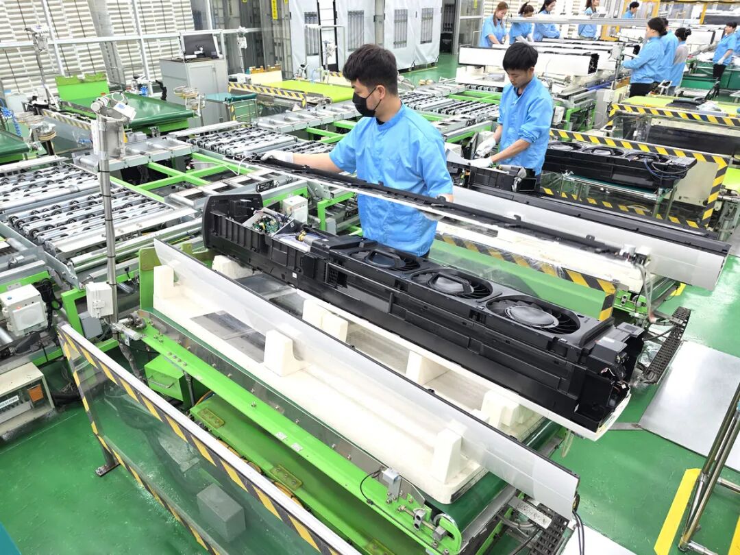 Samsung Electronics employees assemble the 